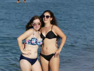 Girl Sticking Out Tongue on Beach in Greece