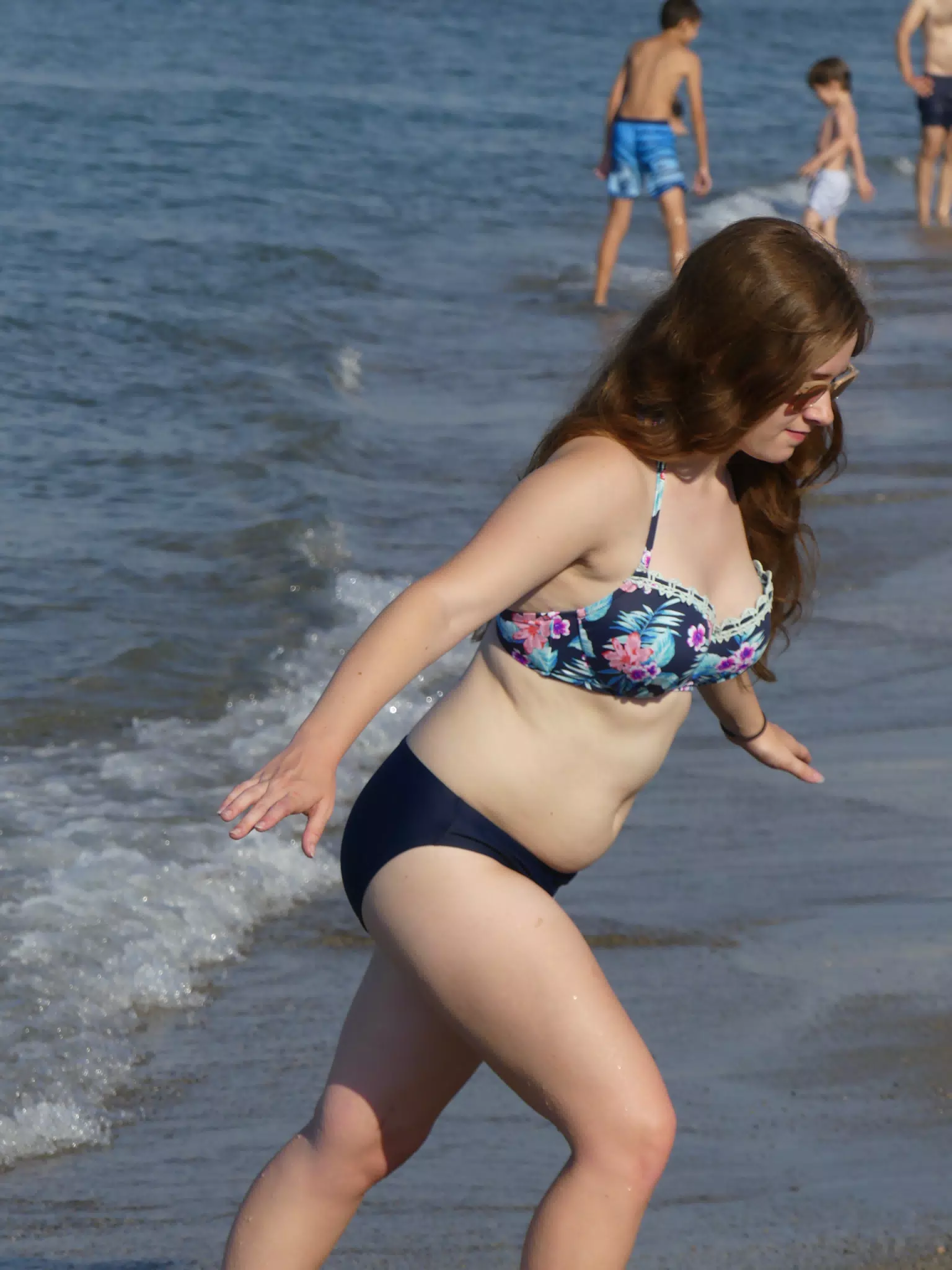 Girl Walking Up Beach