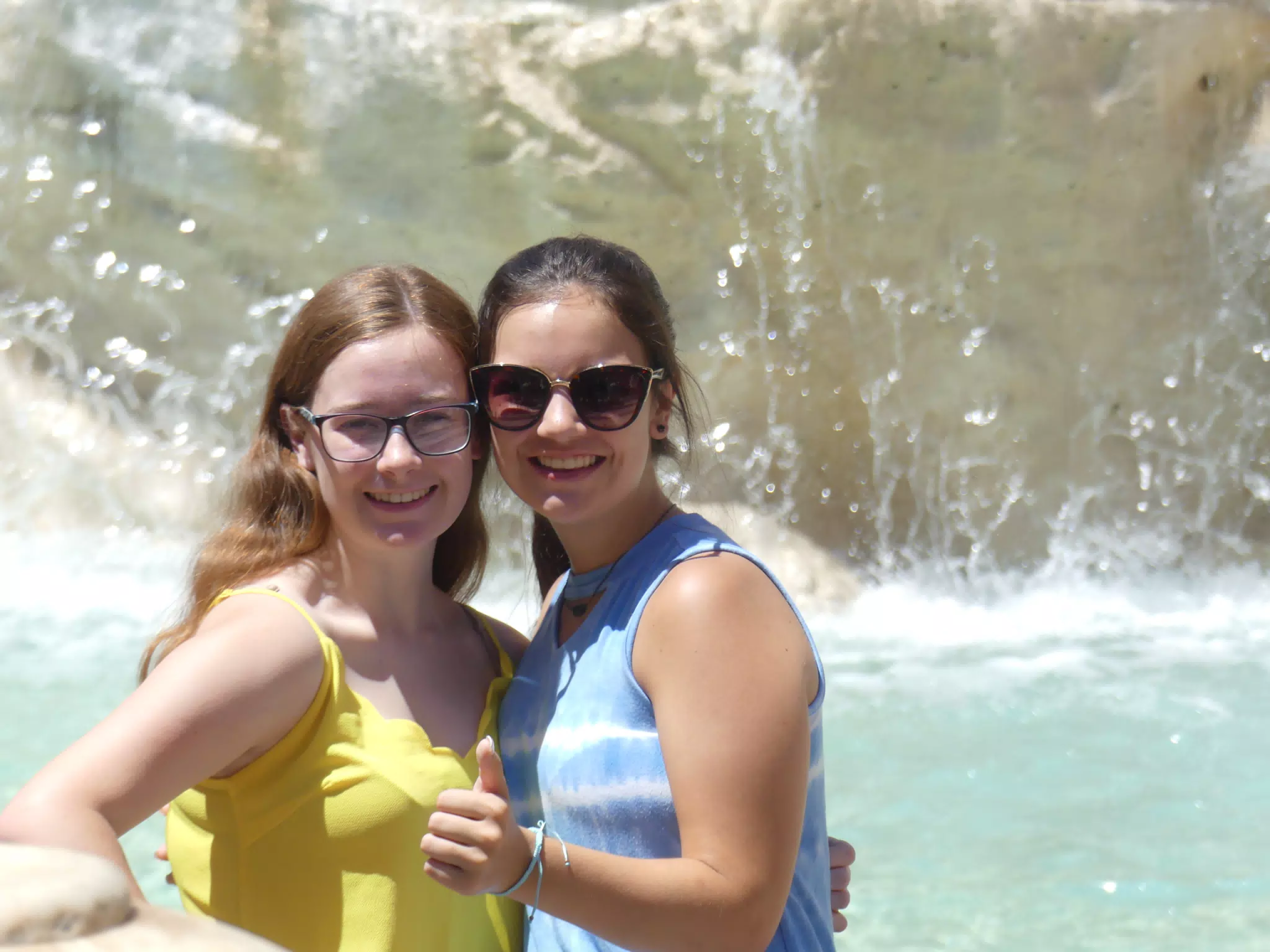 Emily Thumbs Up with Madeline by Fountain