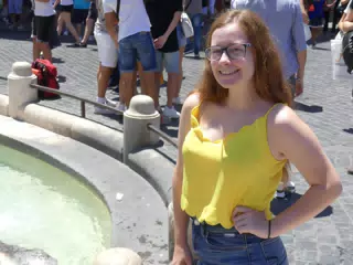 Teen Travel Model Madeline Posing by Fountain in Rome Italy in Yellow