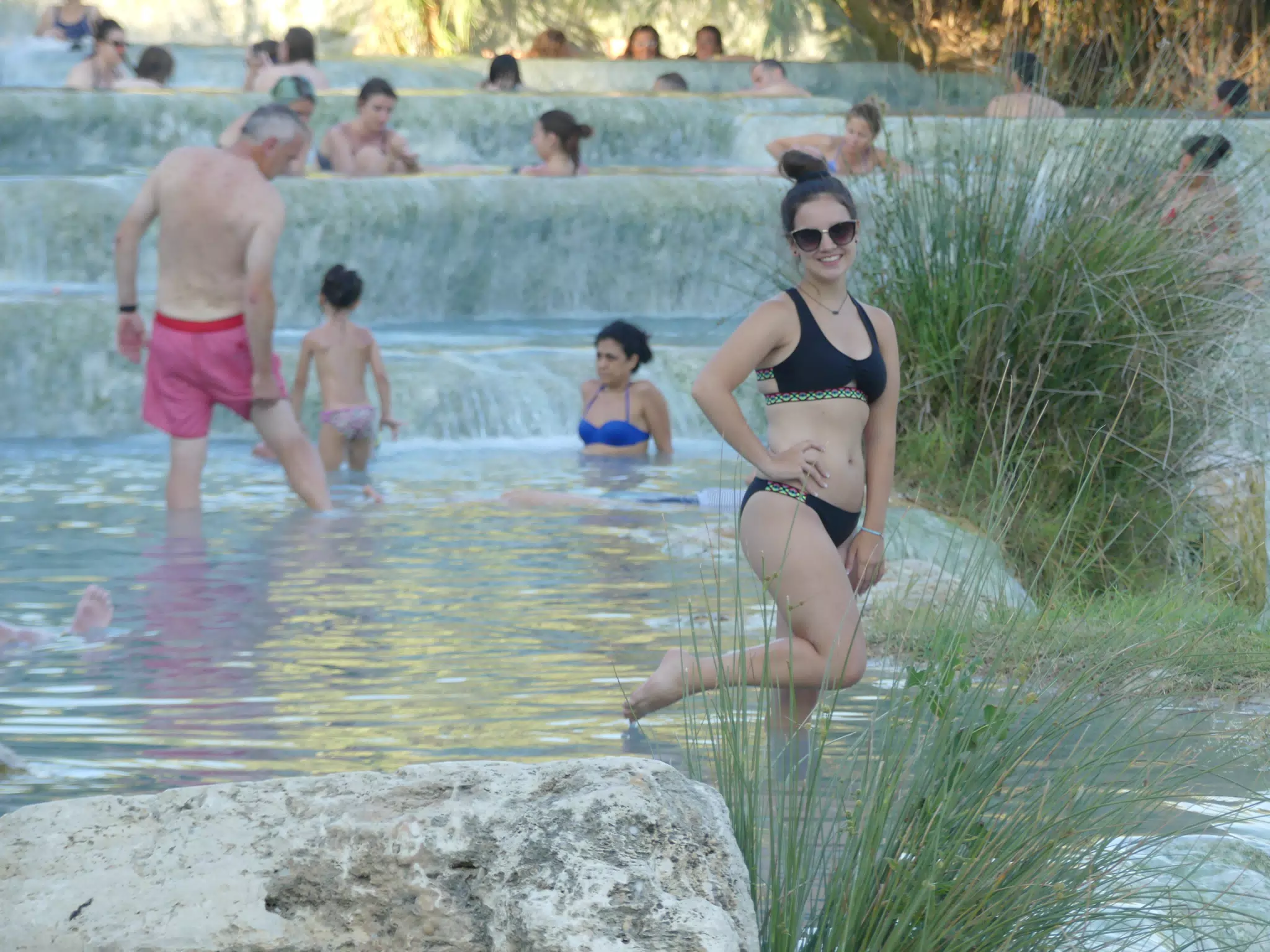 Bikini Clad Teen Model on One Foot in Spa Pool at Saturnia