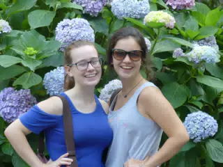 Sisters Laughing by Flowers