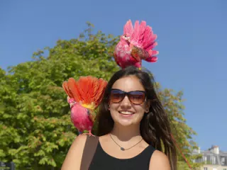 Emily Covered in Colorful Birds in Park in Paris
