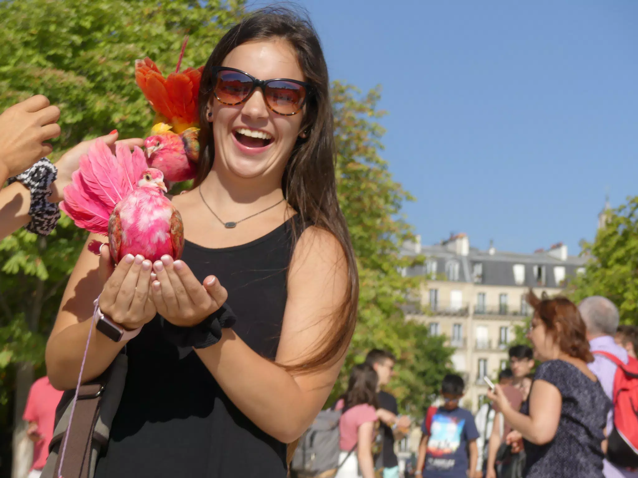 Emily Holding Exotic Bird in Park in Paris