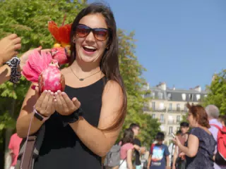 Emily Holding Exotic Bird in Park in Paris