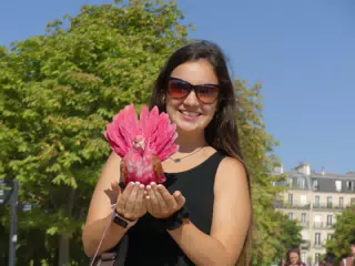 Emily in Paris Park Holding a Pink Bird
