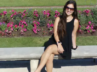 Emily in Black Dress in Parisian Park on Bench