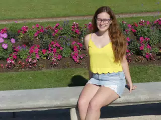 Girl in Jean Skirt on Park Bench