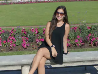 Emily in Black Dress on Bench in Paris Park