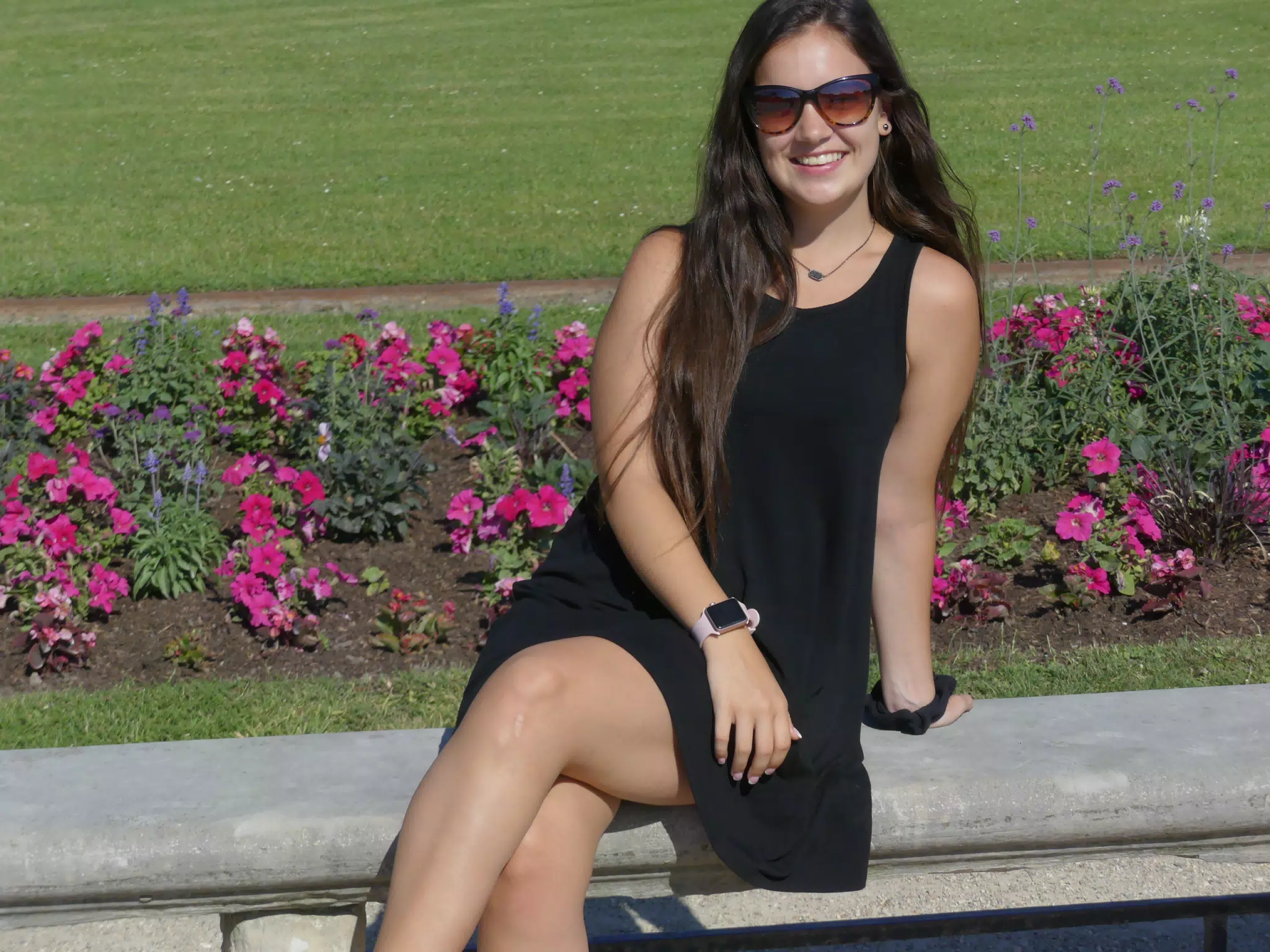 Emily in Black Dress on Park Bench with Flowers in Paris, France