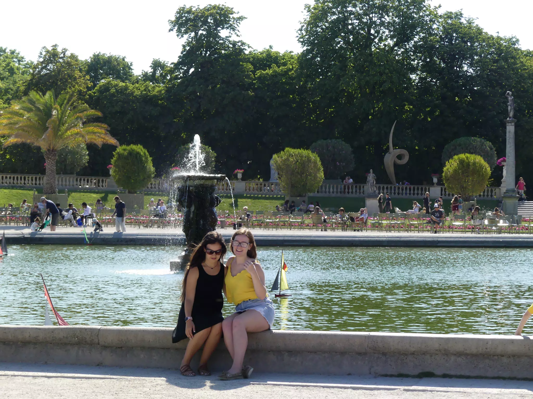 Girls Sitting on Fountain in Paris