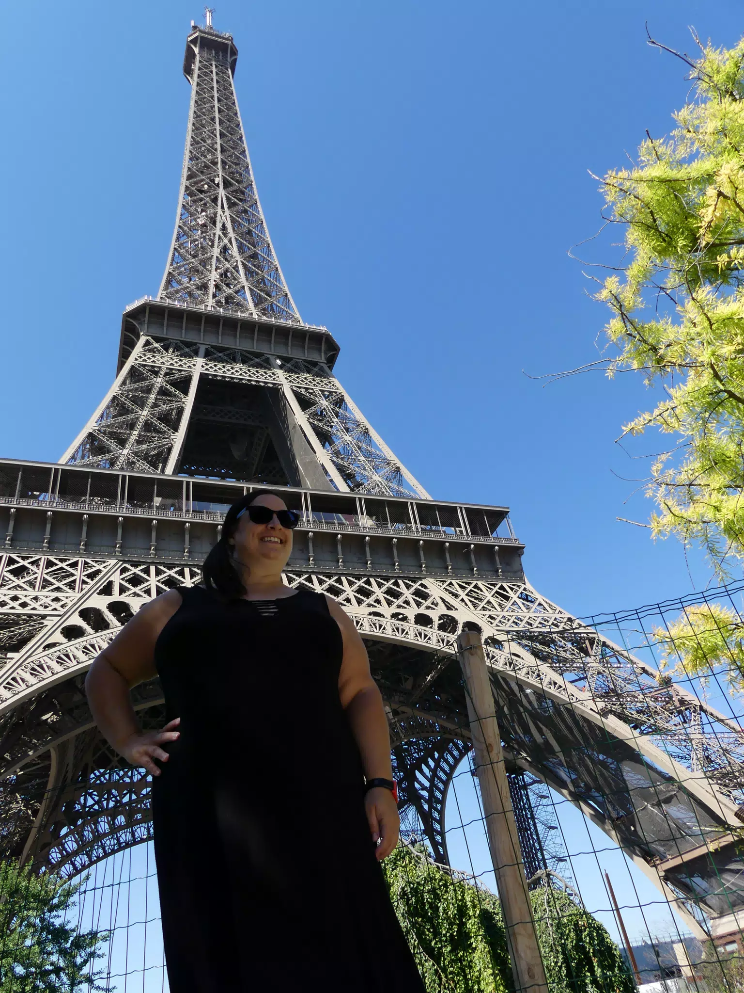 Woman in Black Dress Under Eiffel Tower