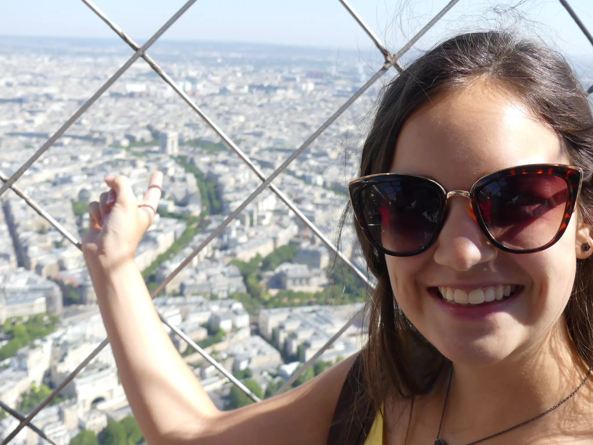 Emily Pointing to the Arc d'Triumph from the Eiffel Tower