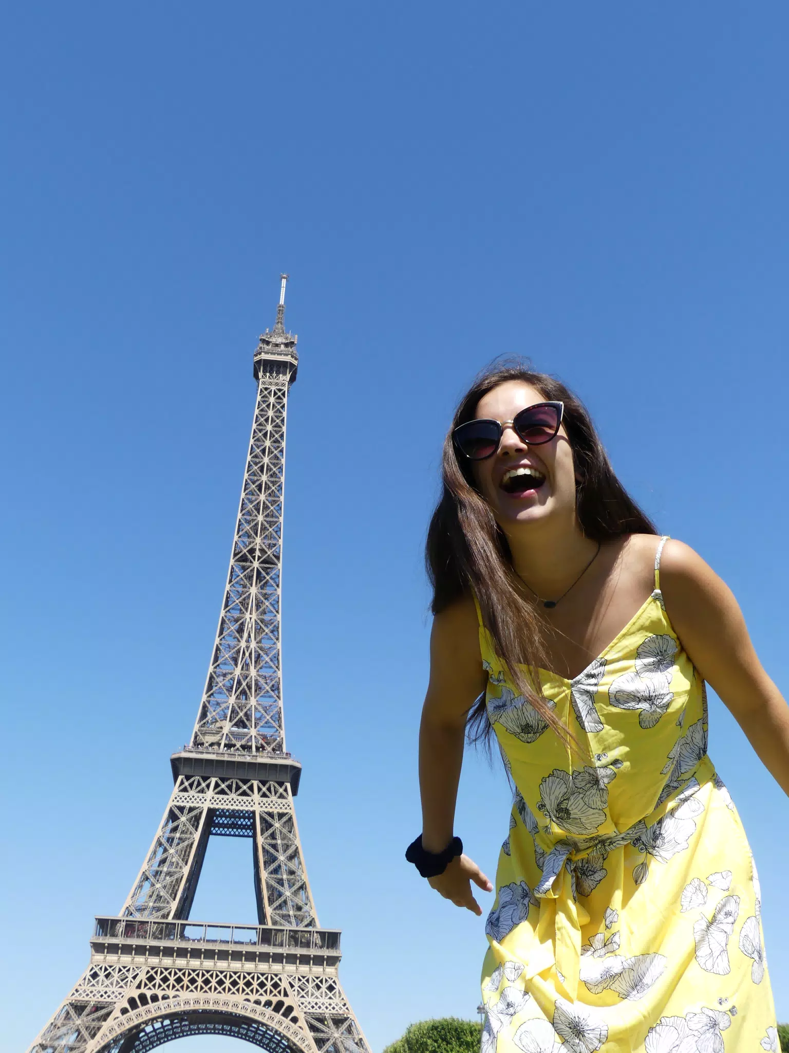 Teen Brunette Laughing at the Eiffel Tower in Yellow Dress