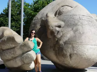 Emily in Paris with Giant Head Statue