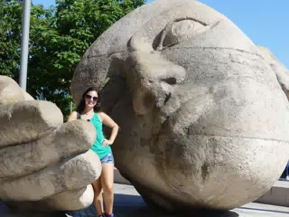 Emily with Giant Statue in Paris