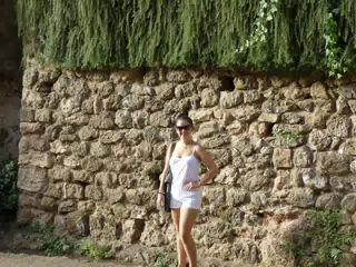 Teen Model in White by Stone Wall in Barcelona