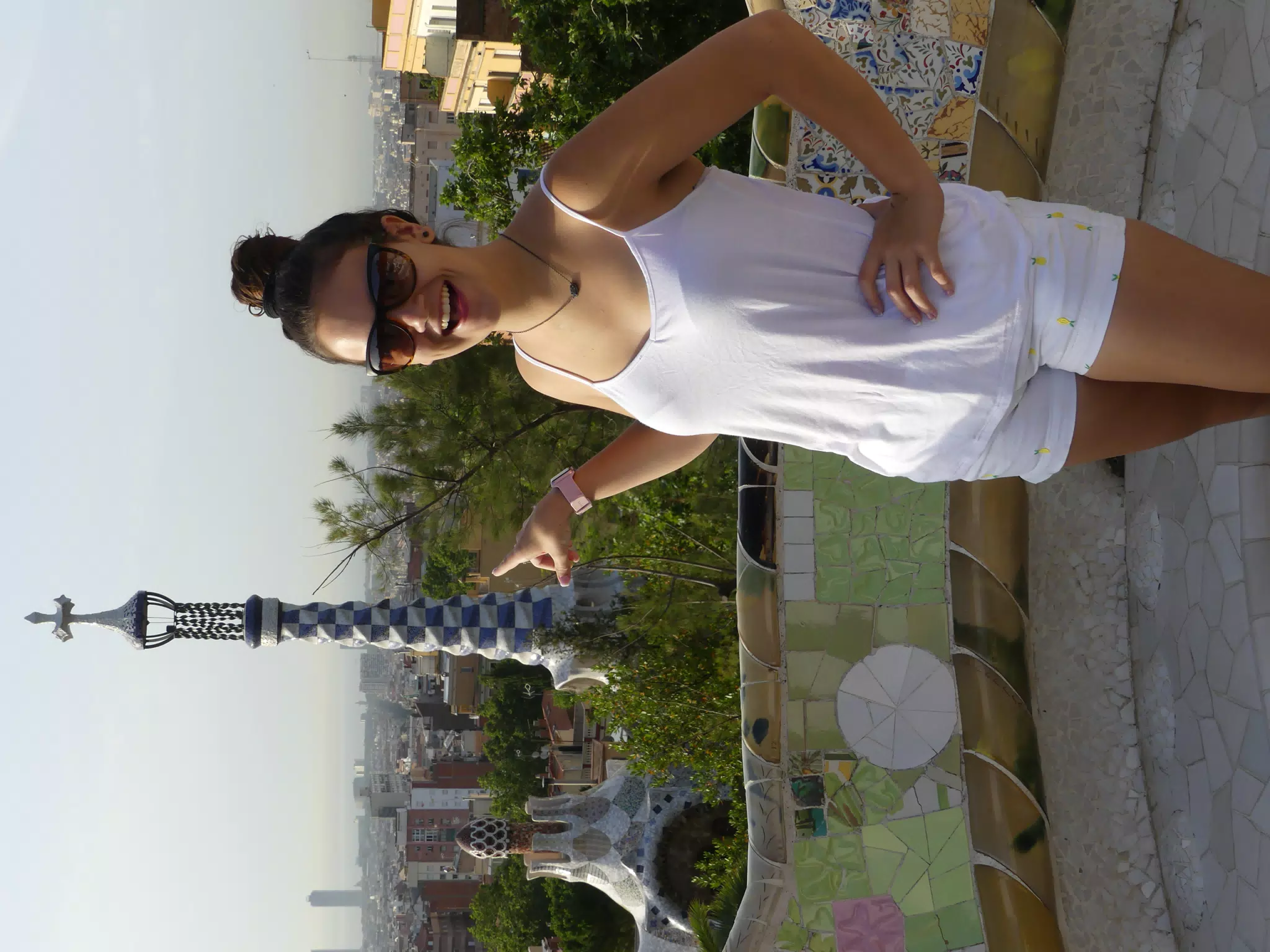 Emily in Barcelona Modeling in White Pointing Out to the City