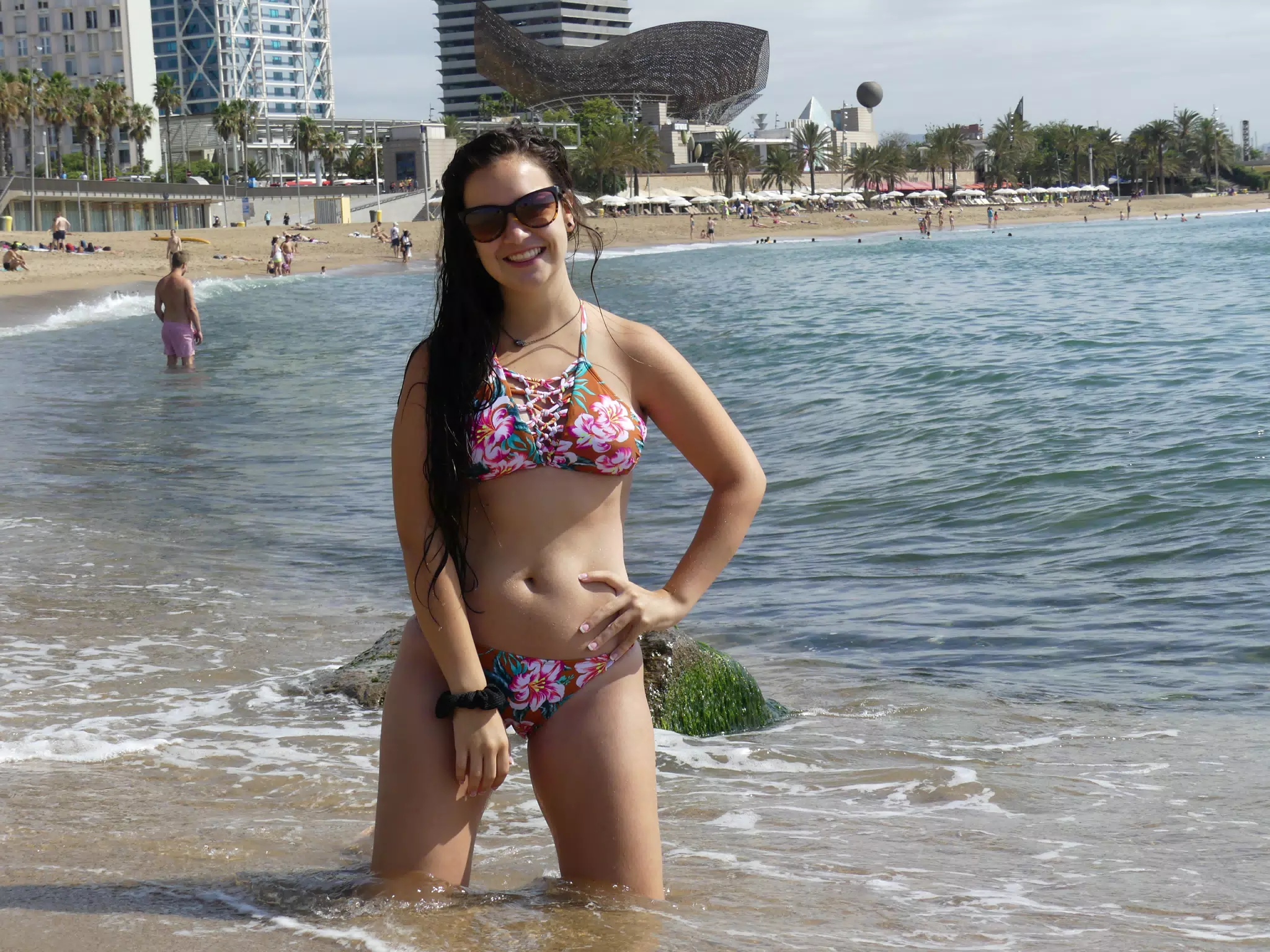 Teen Bikini Model on Knees in Mediterranean Sea on Beach in Barcelona Spain