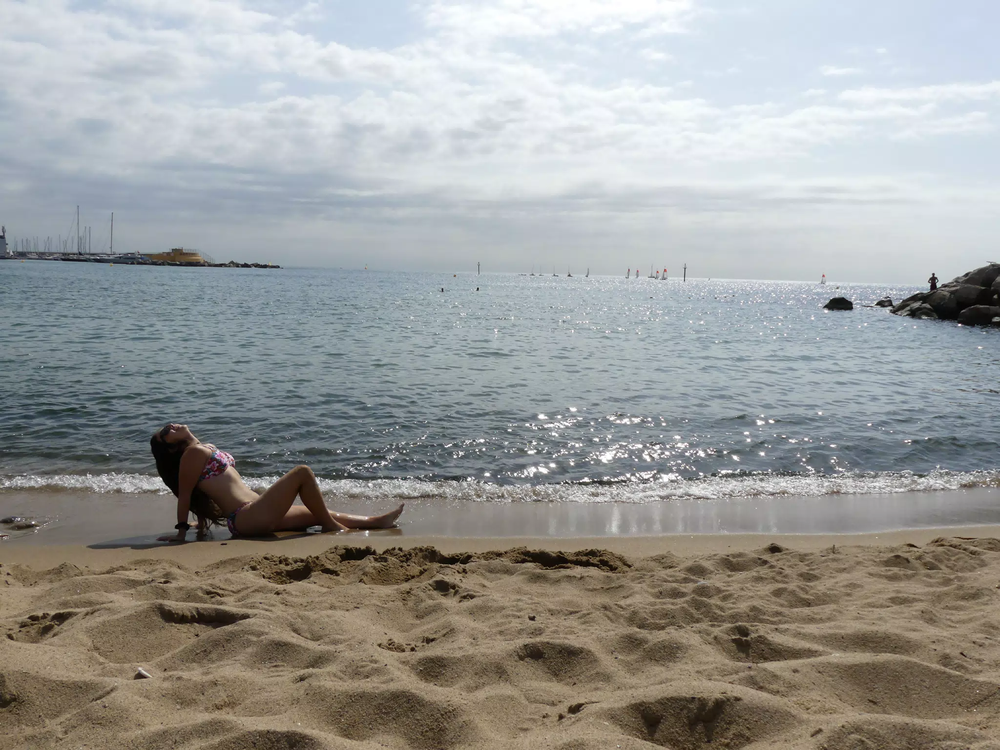 Girl Reclining on Barcelona Beach in Sunrise