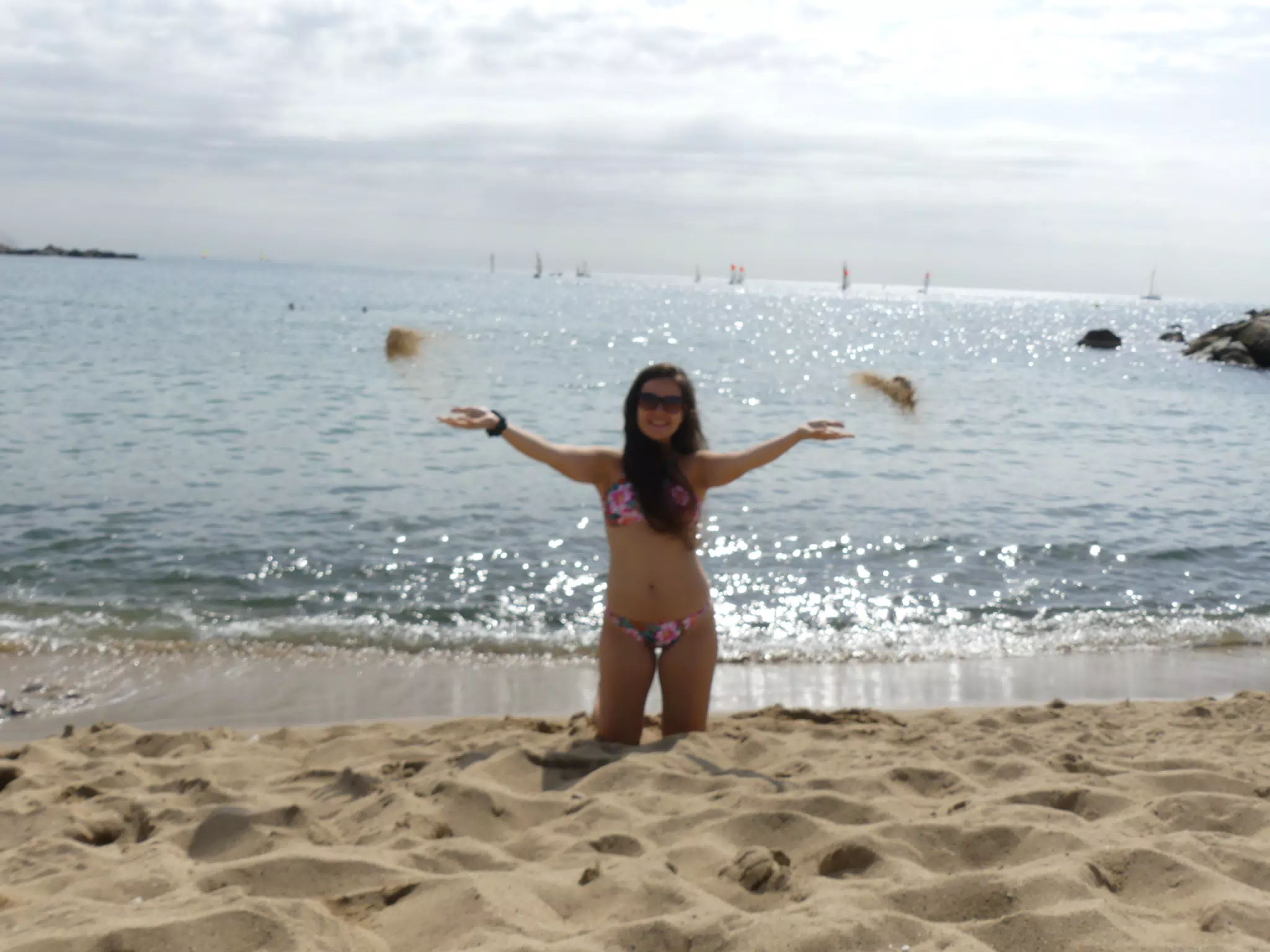 Girl Tossing Sand on Beach