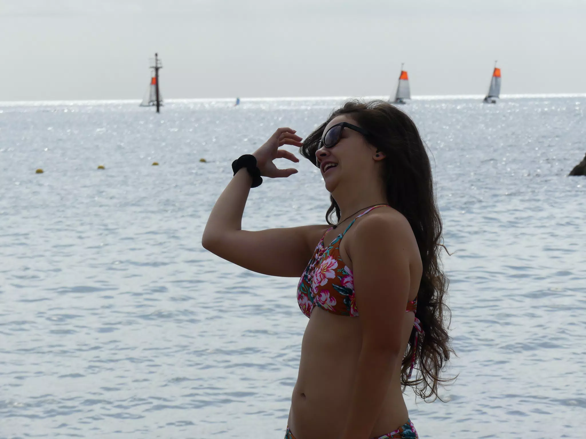Model Fixing Hair on Beach