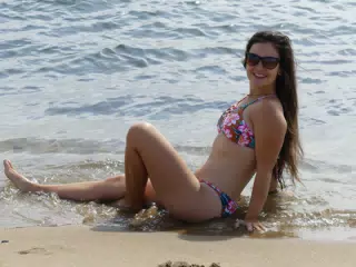 Brunette Lounging on Beach in Barcelona