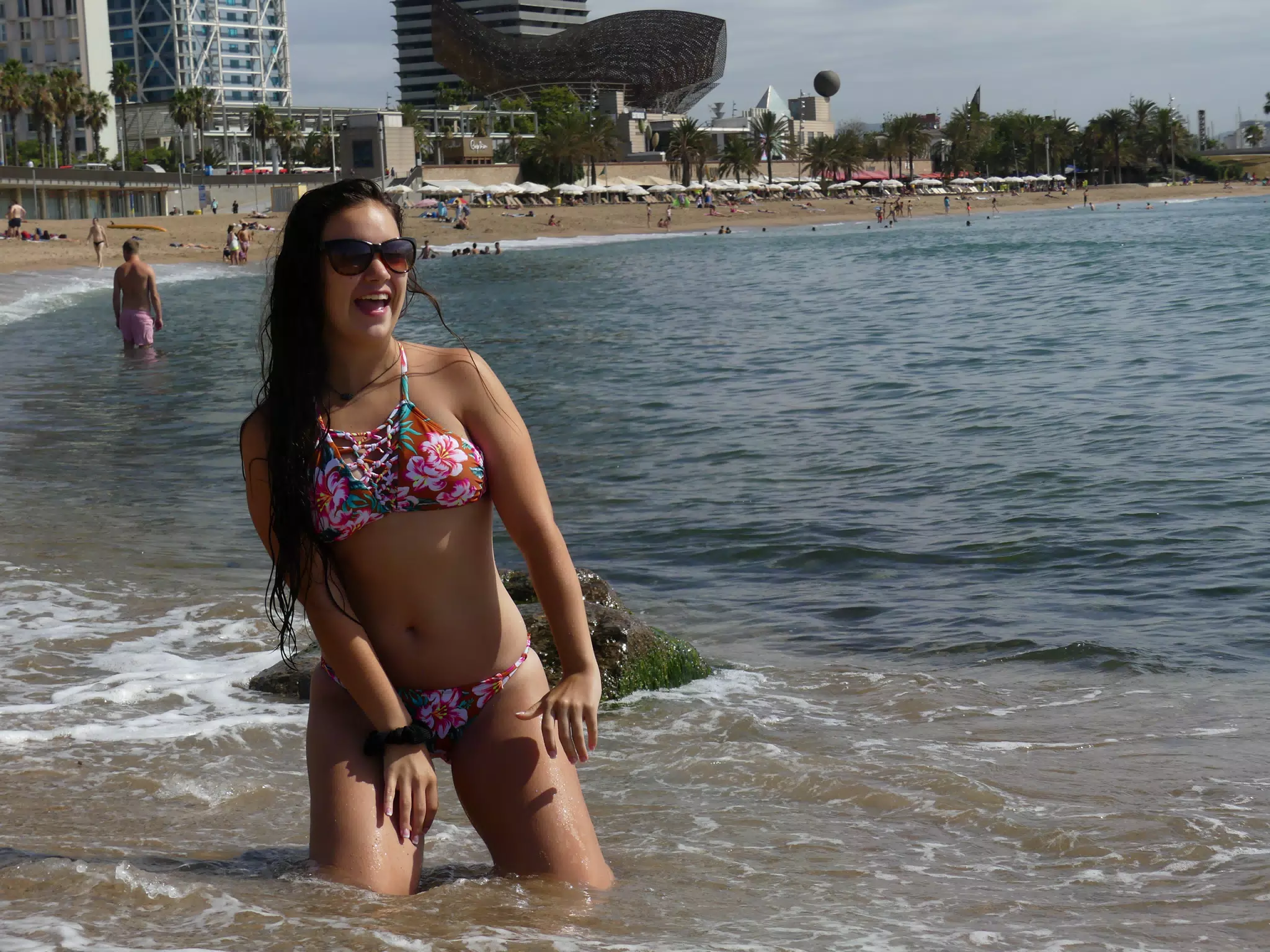 Bikini Model in Barcelona Laughing as Waves Come In to the Beach