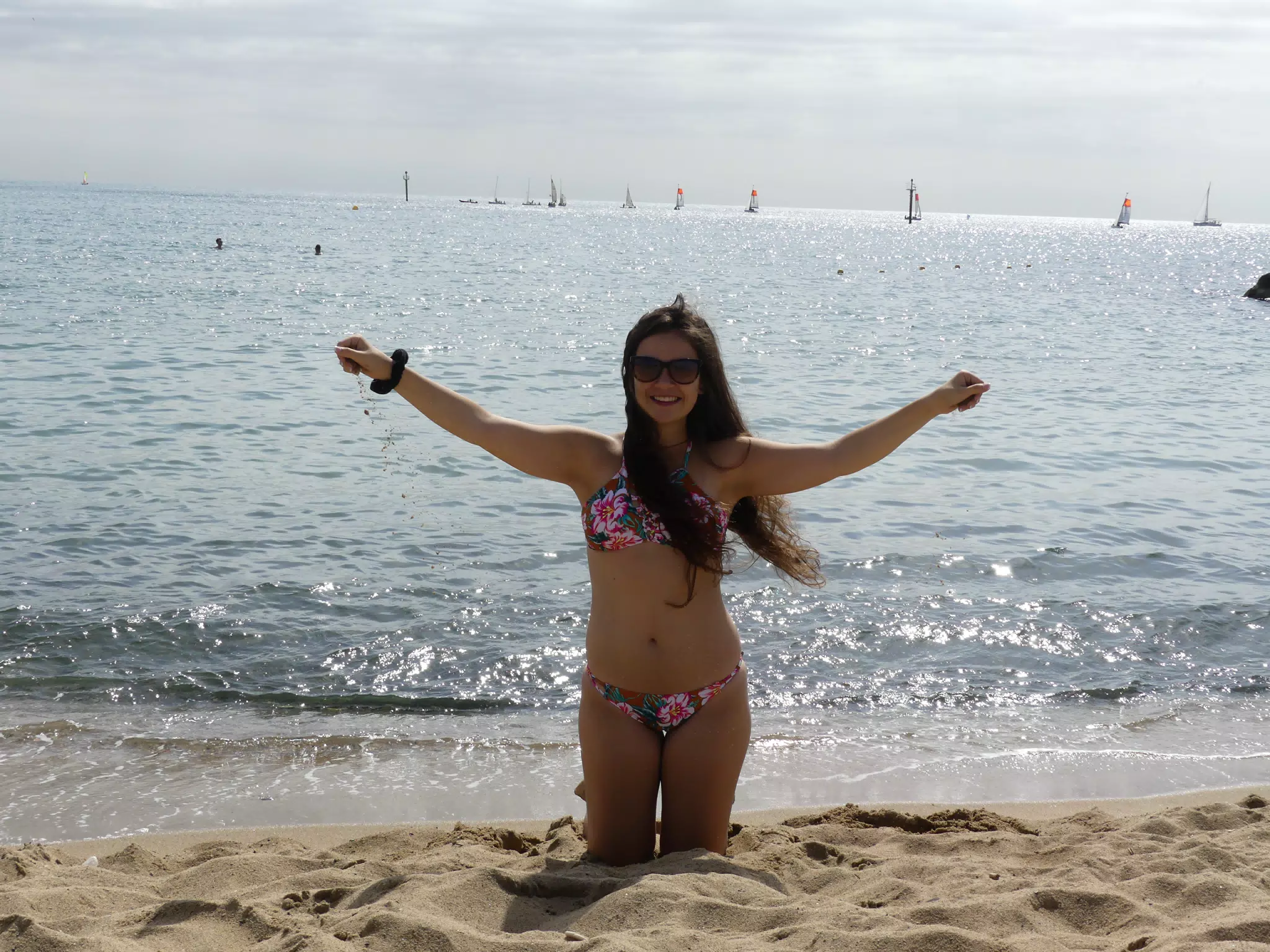 Emily Dropping Sand on Beach in Barcelona