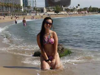 Girl in Bikini on Knees in Sea on Barcelona Beach