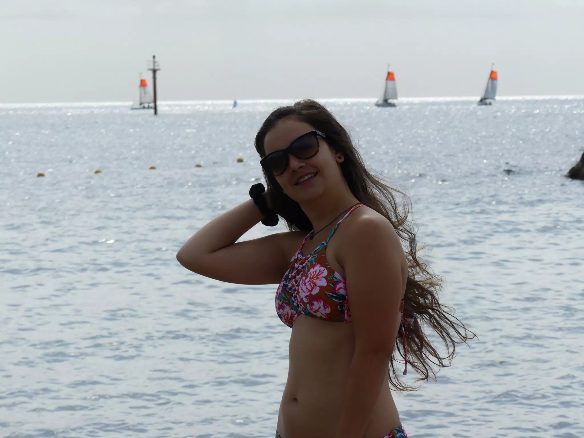 Girl Fixing Hair on the Beach