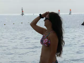 Teen Bikini Model Fixing Hair on Barcelona Beach in Swimsuit