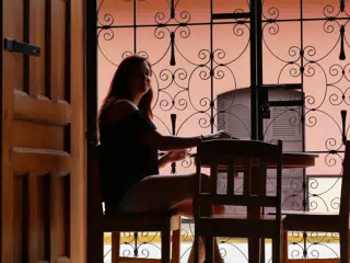 Rachel in Window of El Almirante in Granada