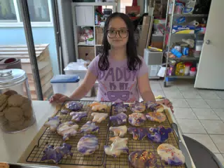Luciana Showing Off Their Decorated Cookies