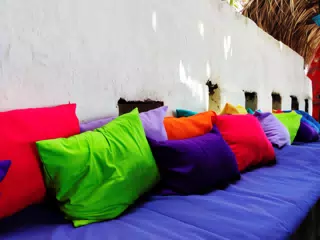 Colourful Pillows on the Outside Bench at the Simple Beach Lodge