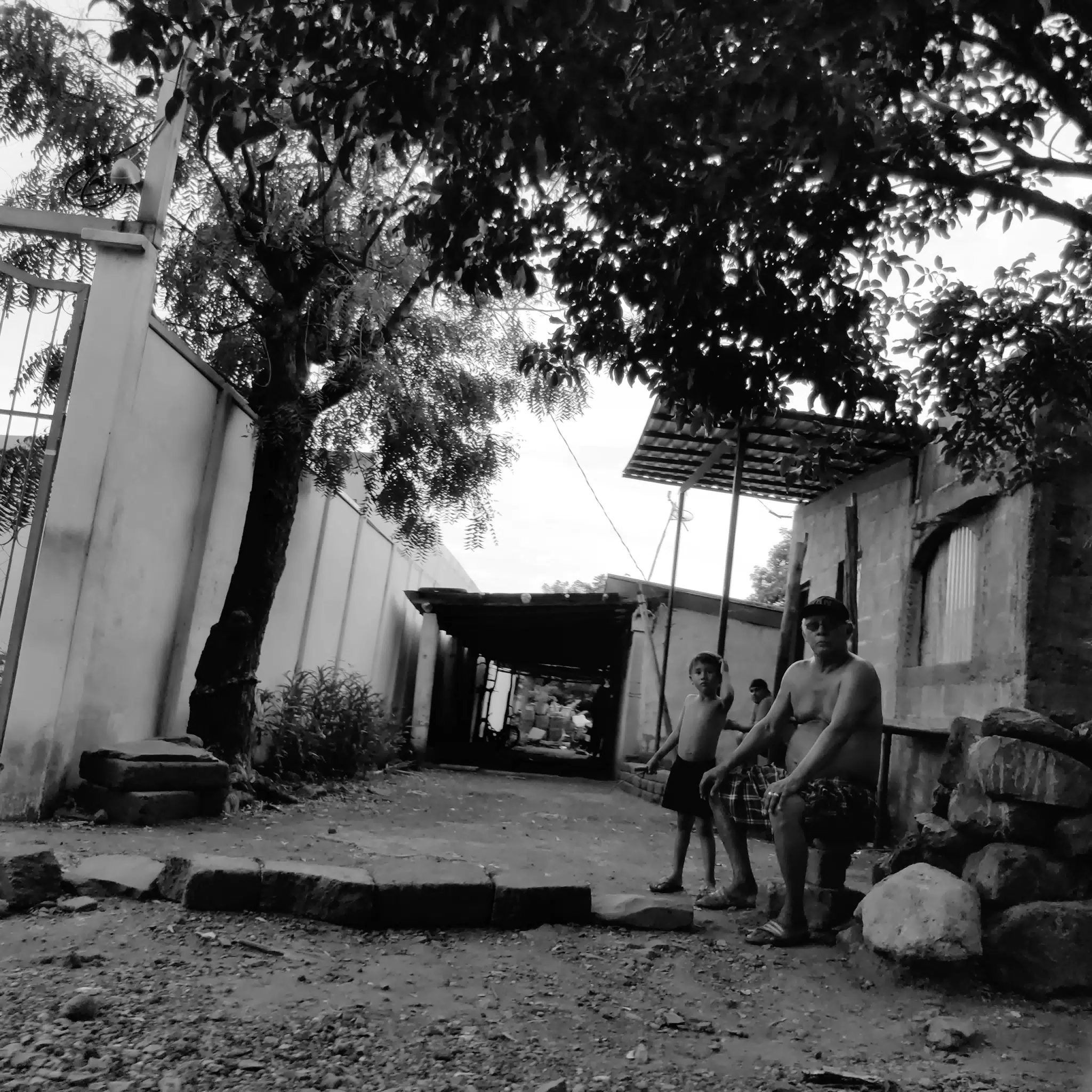 Man and Boy Sitting on Backstreet - Photowalk July 31