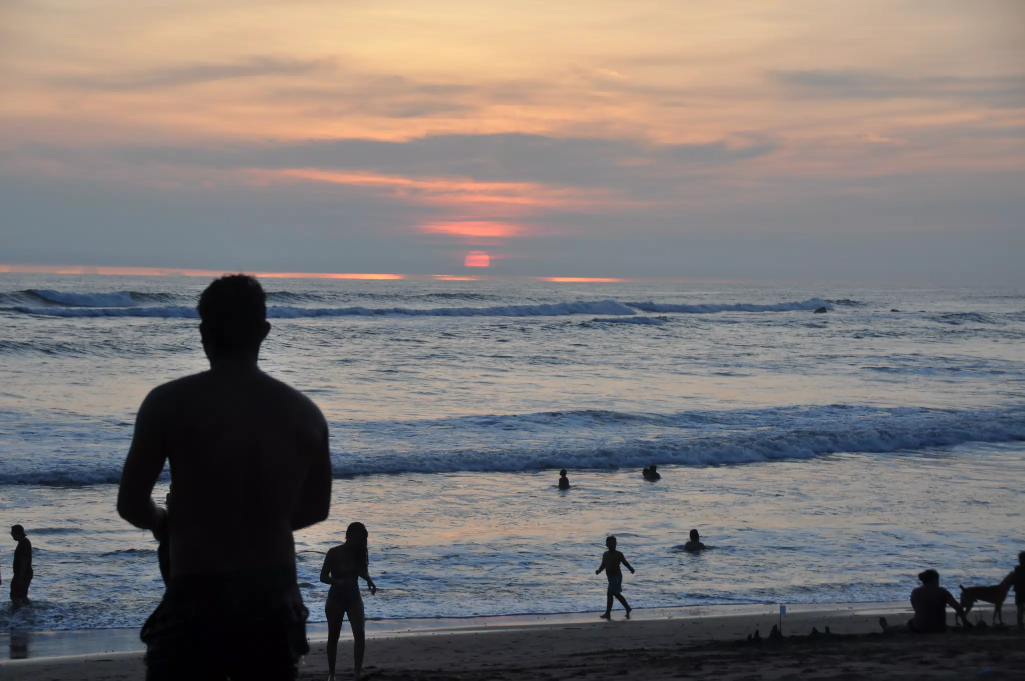 Swimmers in Pacific Ocean in Nicaragua at Sunset