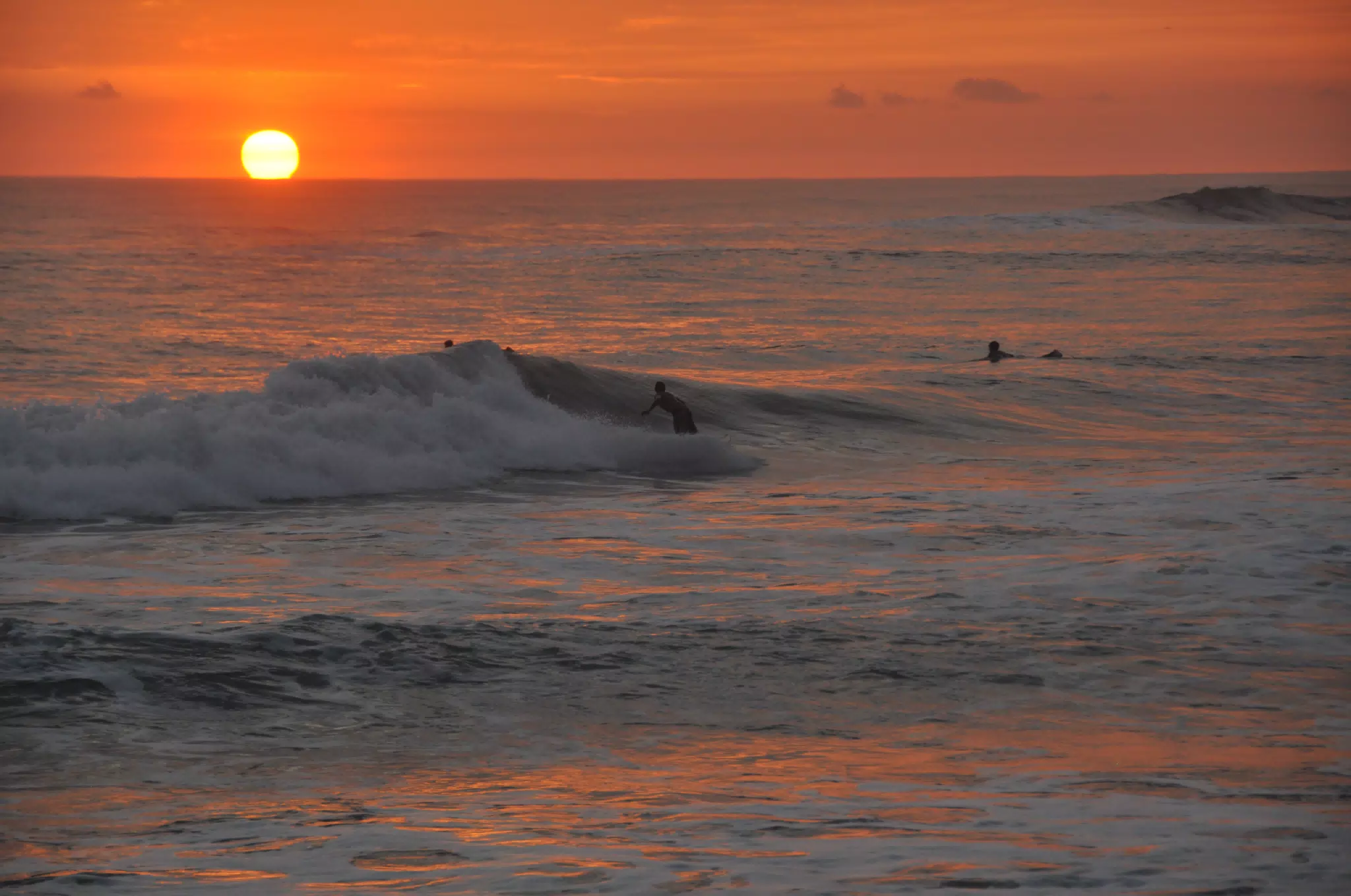 Surfers in Pacific Ocean at Las Penitas at Sunset