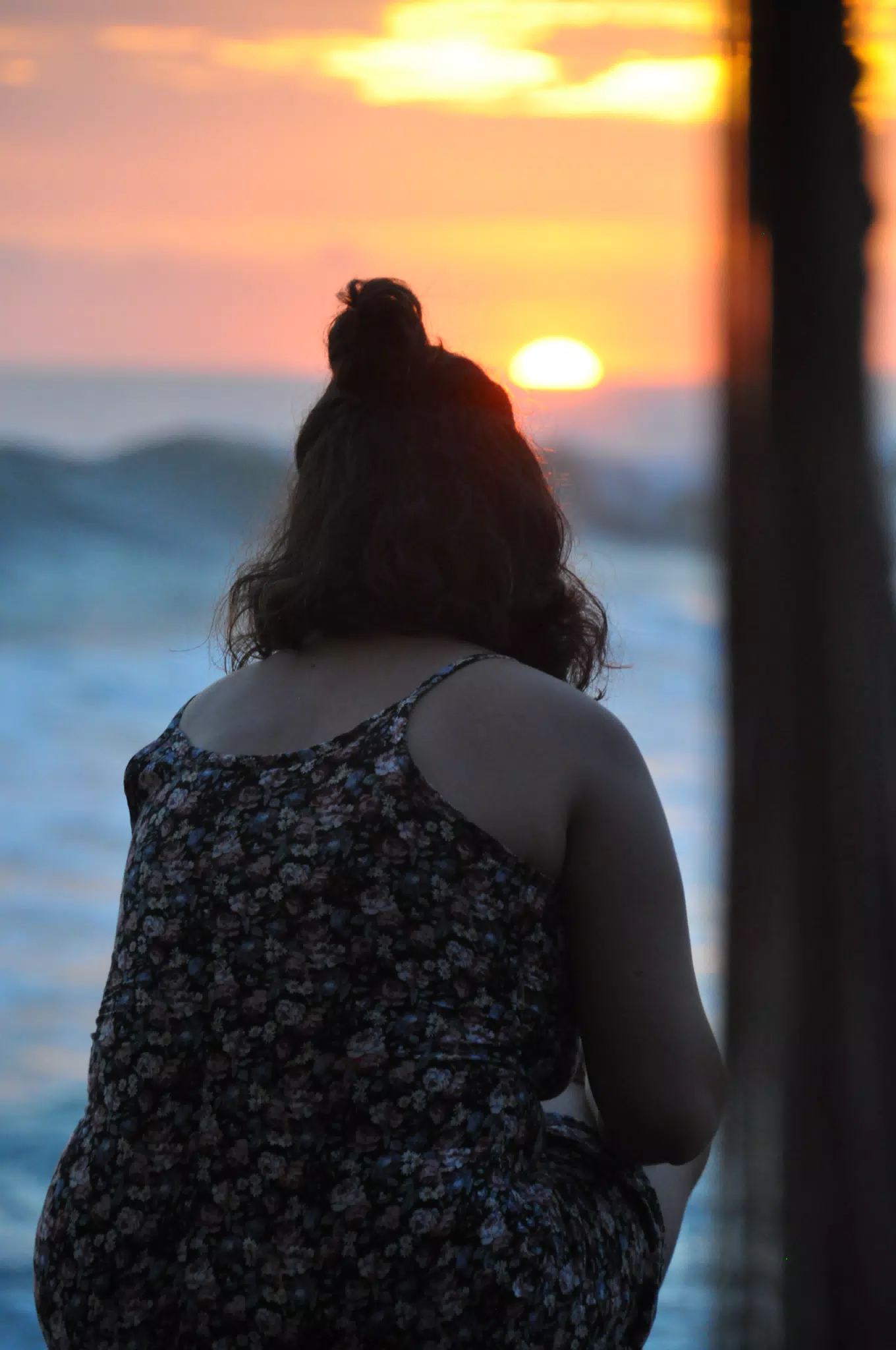 Girl Watching Sunset over Pacific Ocean