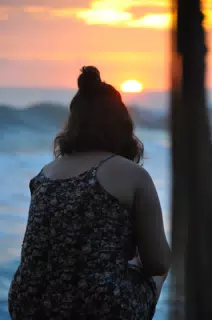 Girl Watching Sunset over Pacific Ocean
