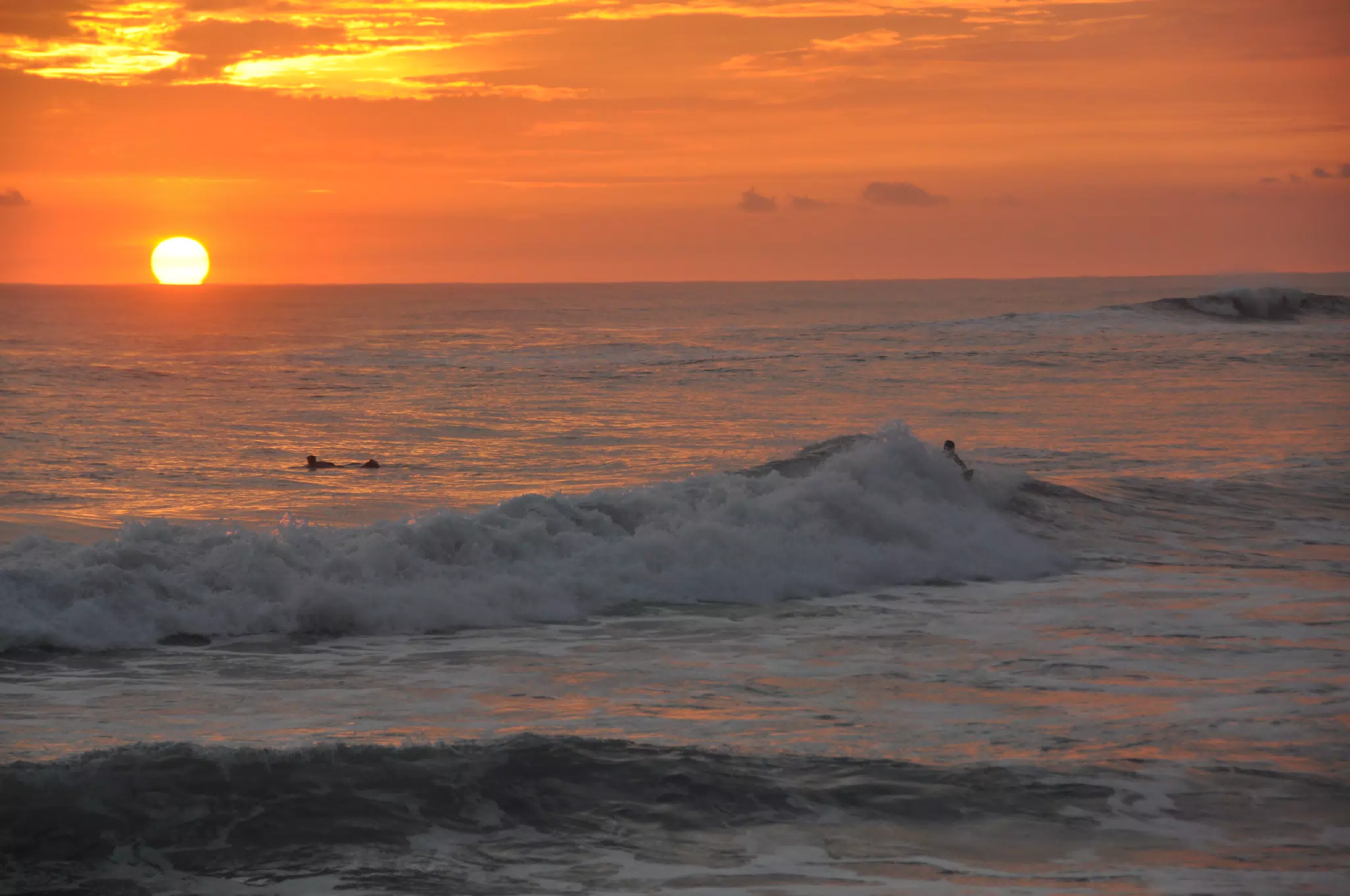 Surfers Attempting a Sunset Ride in Las Peñitas