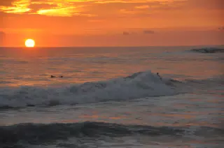 Surfers Attempting a Sunset Ride in Las Peñitas