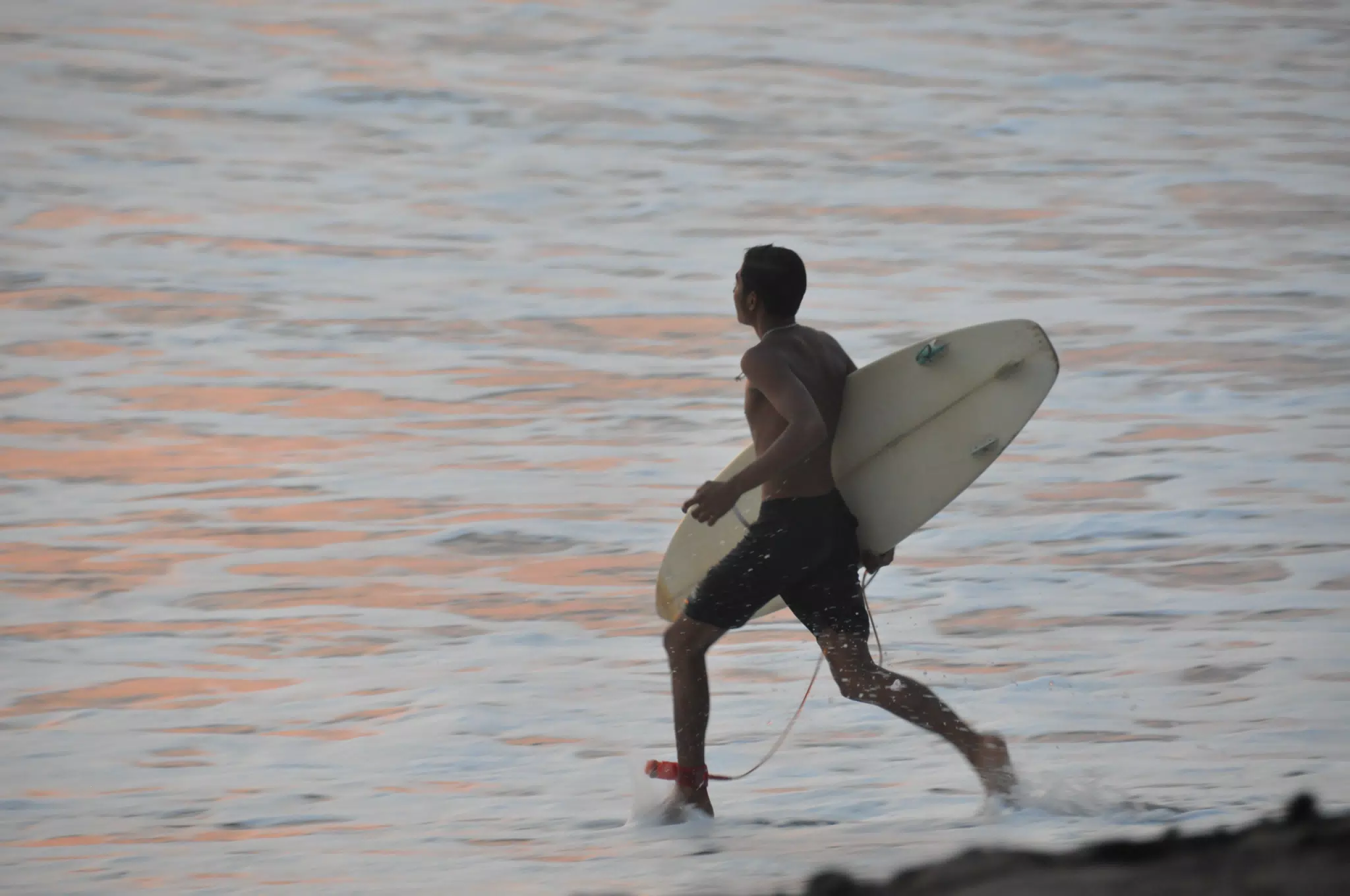 Surfer Running Into the Pacific