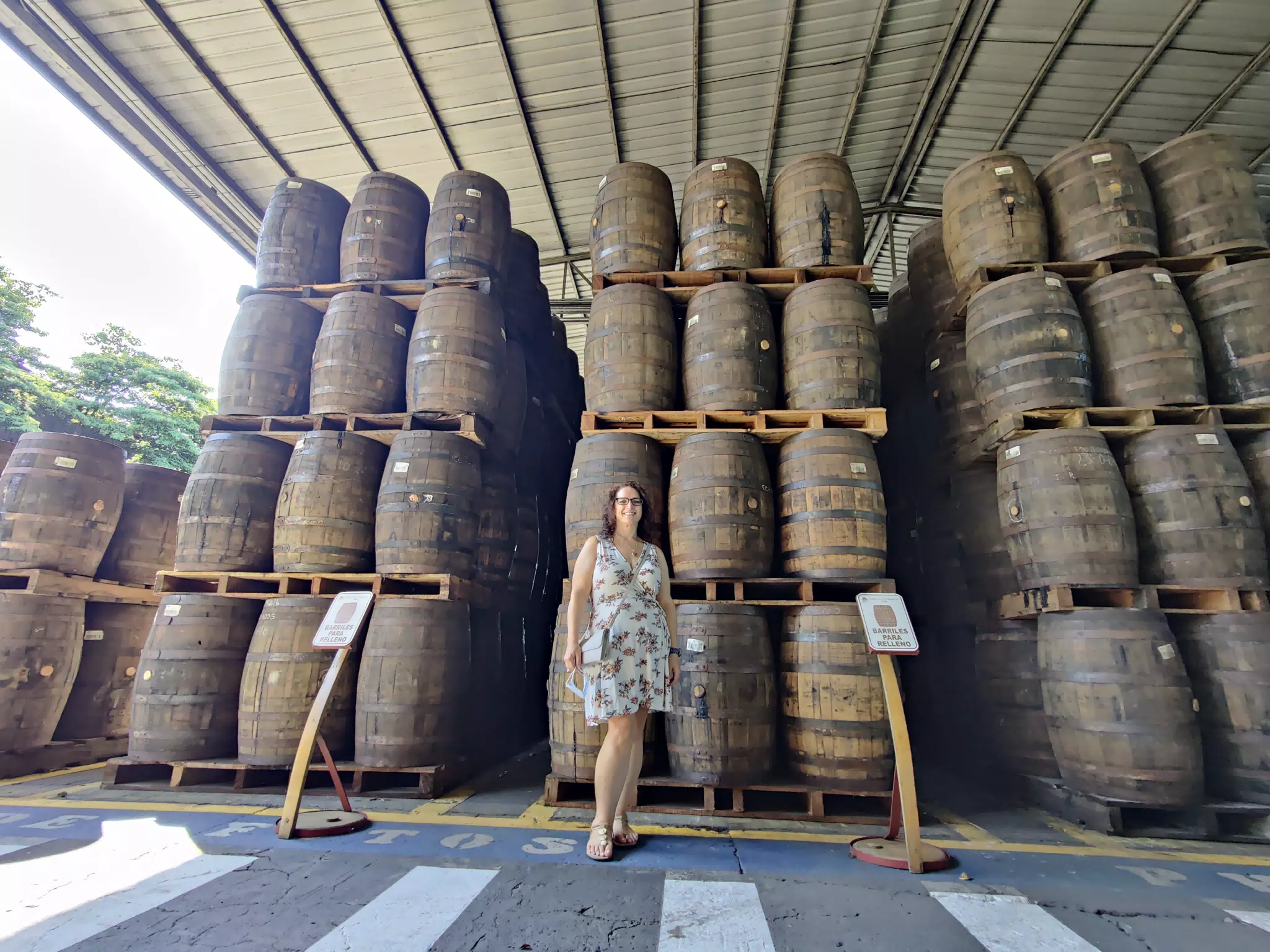Dominica Posing with Rum Barrels on the Flor de Caña Tour