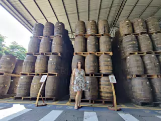 Dominica Posing with Rum Barrels on the Flor de Caña Tour
