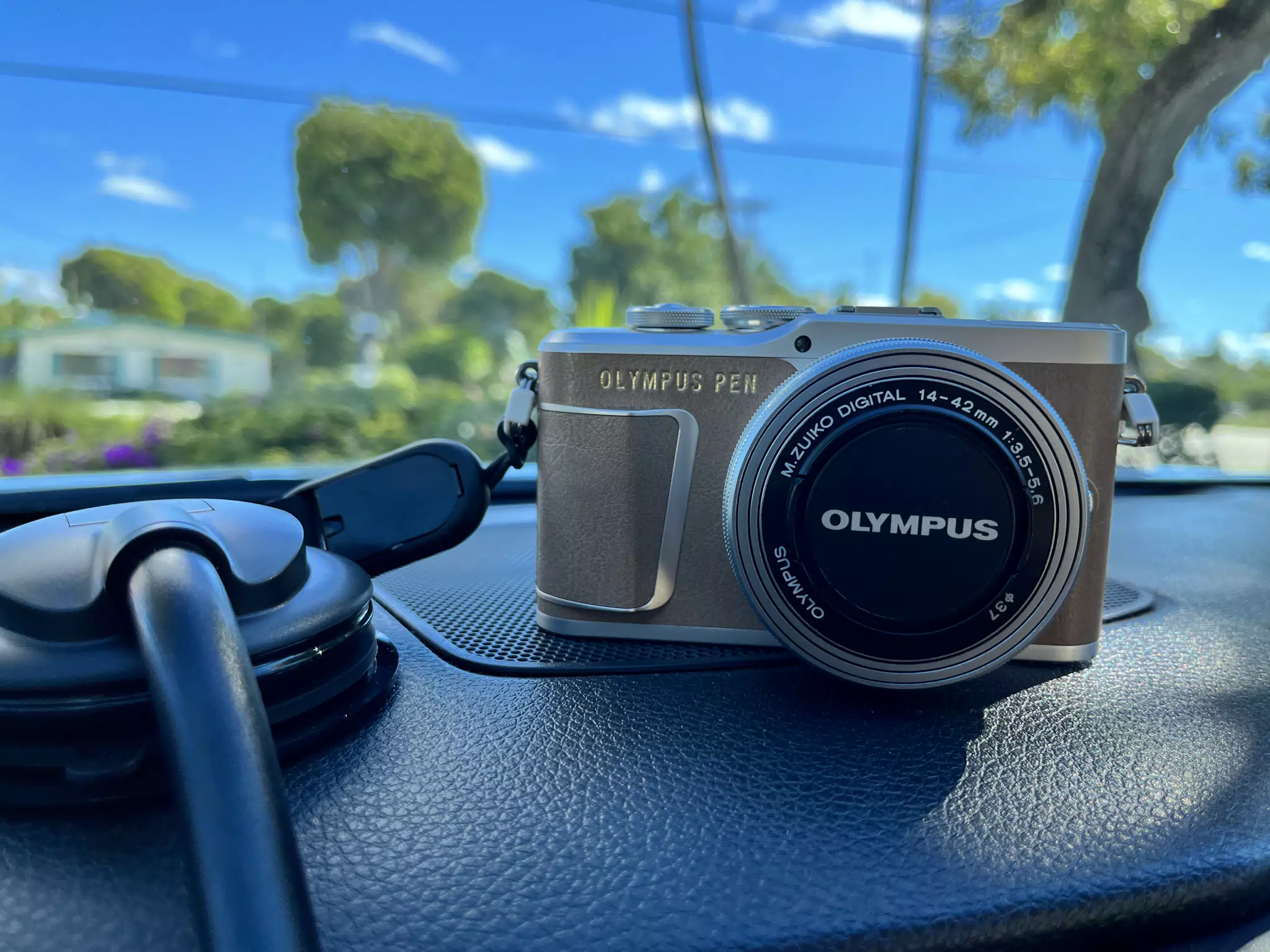 Olympus PEN E-PL9 & M.Zuiko 14-42mm Kit Lens on Car Dash in Mocha