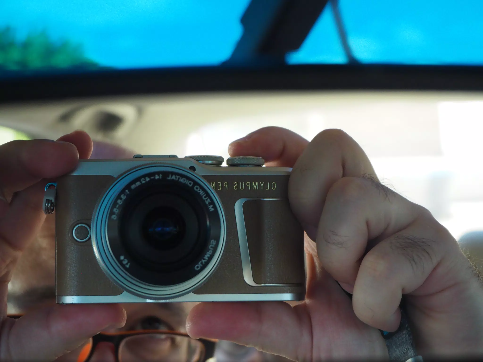 Selfie of Olympus PEN E-PL9 in Rearview Mirror