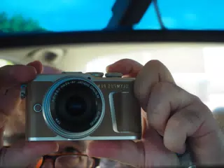 Selfie of Olympus PEN E-PL9 in Rearview Mirror