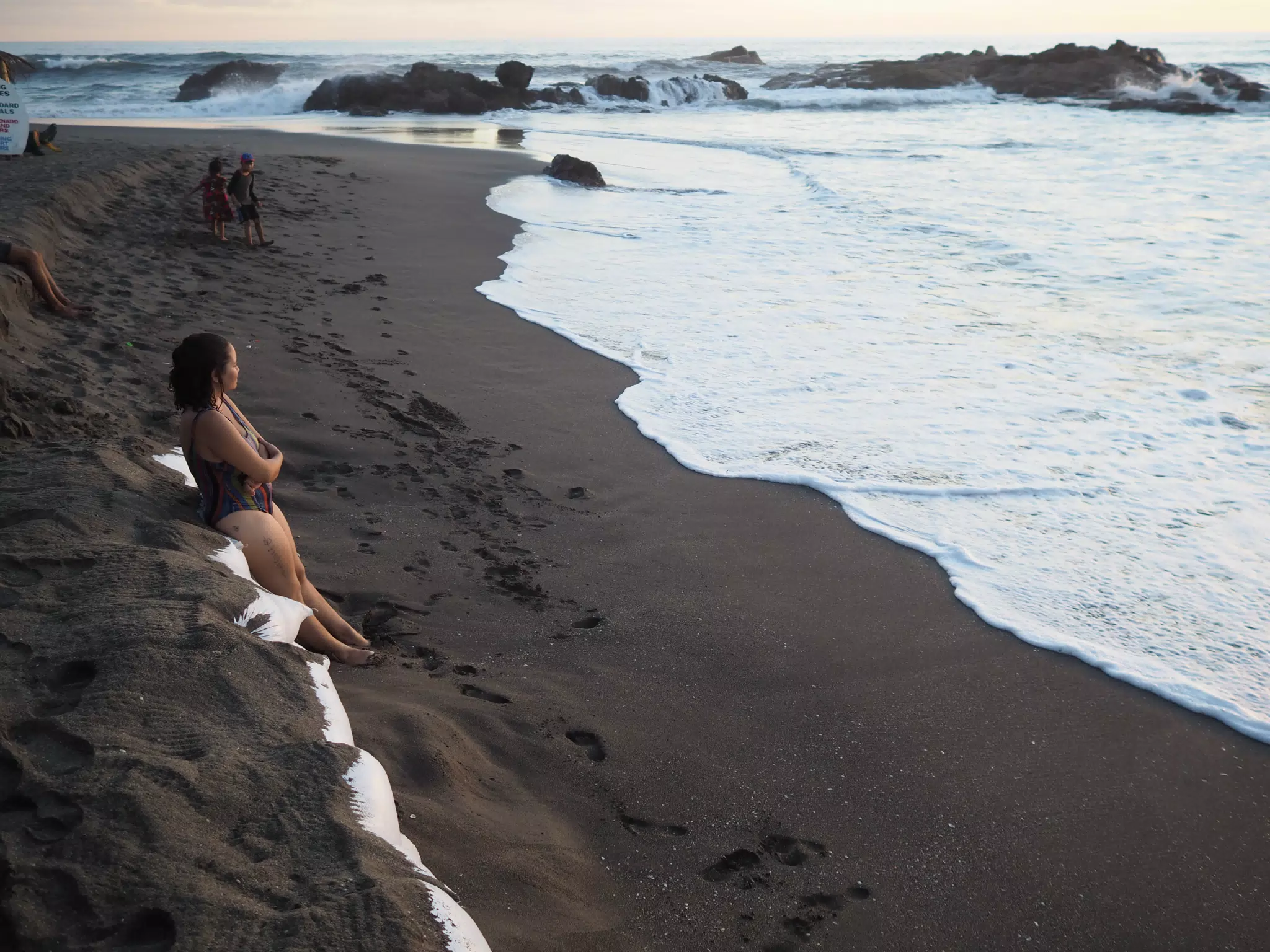 Ivonne on Sand Bags on Eroded Beach at Las Penitas