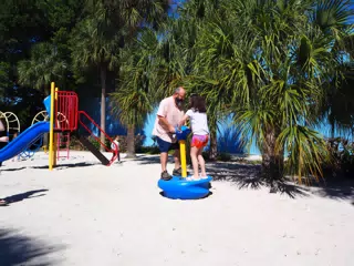 Ciana and Dad on Playground at Library Beach